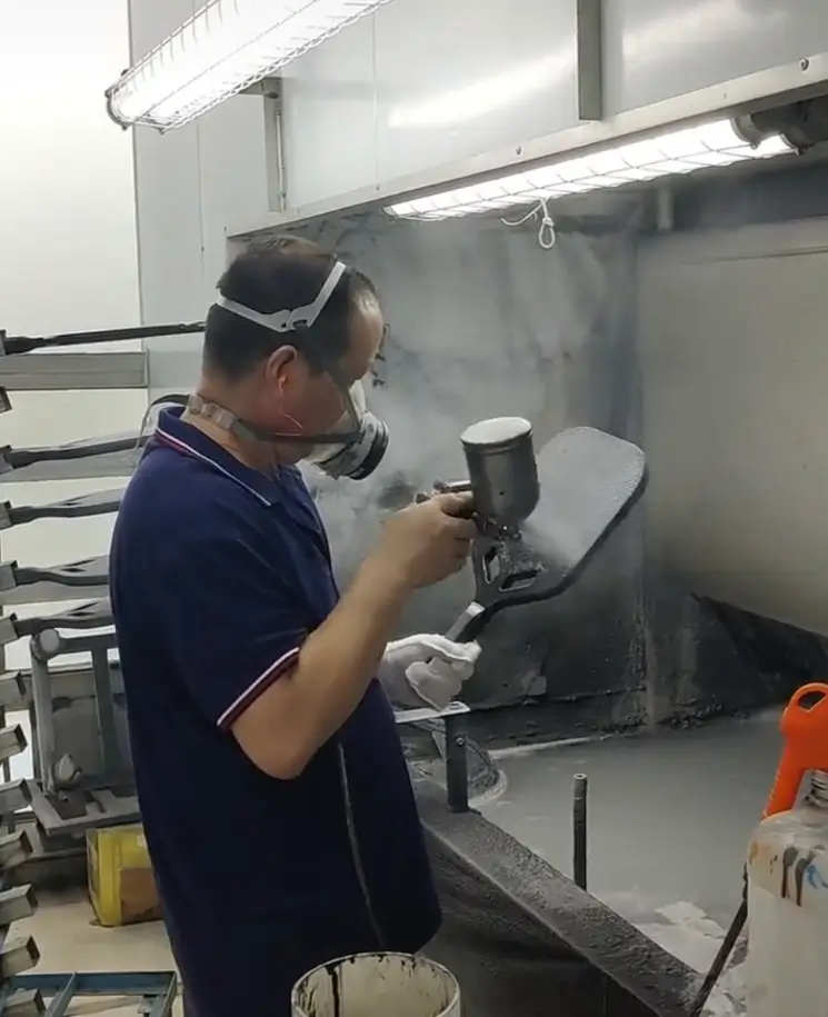 Precision sandblasting process at ApexonSport factory, creating a uniform matte texture on carbon fiber paddles for a premium look and feel.