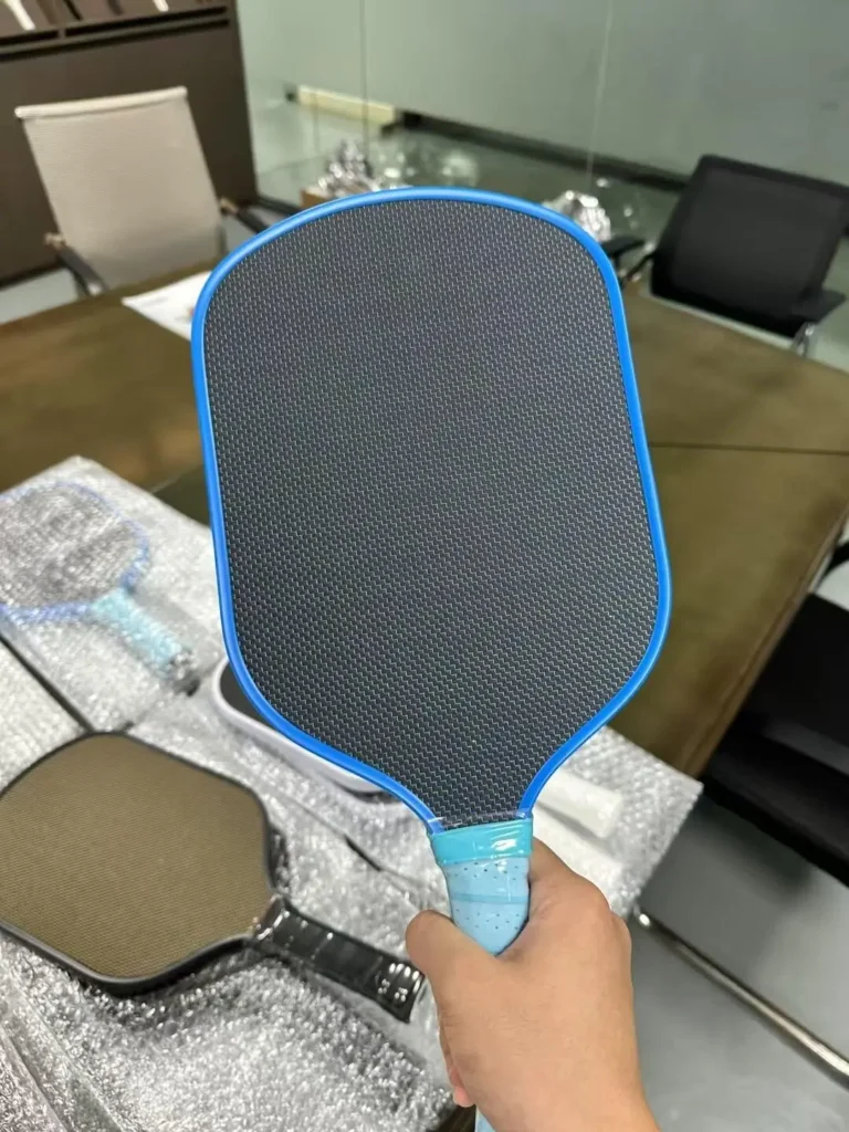 Branded pickleball paddle collection product photography for retail display showing coordinated paddle face graphics and packaging